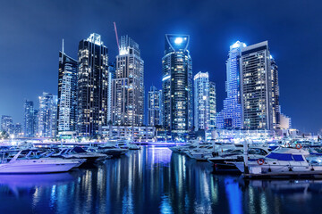 Fototapeta na wymiar Marina with yachts and skyscrapers in Dubai UAE at night