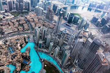 Dubai UAE aerial rooftop view from Burj Khalifa in clouds.