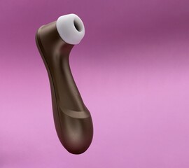 Sucking erotic toy to give pleasure to women isolated on pink background