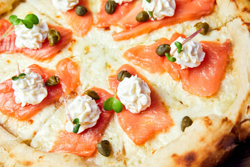 Pizza with salmon and cream cheese. Close-up, selective focus