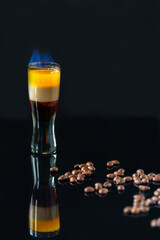 B-52 cocktail flambe (flamed) - layered shot composed of coffee liqueur, Irish cream and orange liqueur