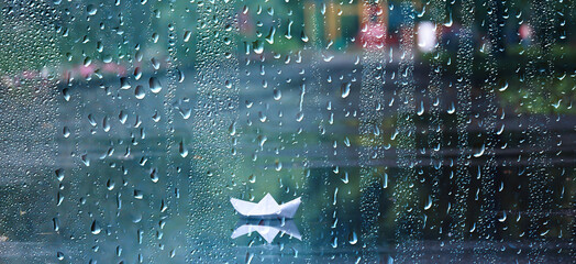 paper boat puddle game, boy seasonal autumn look raincoat, yellow rubber boots, outdoor game