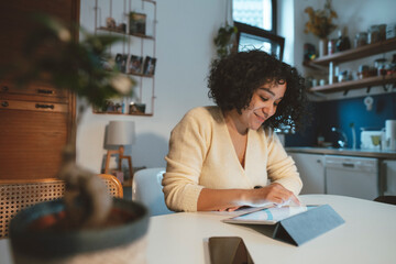 Smiling woman using tablet PC at home