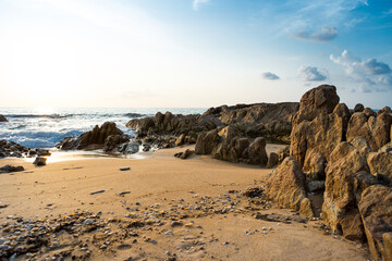 Fototapeta na wymiar Rock beach background, sunset at the beach, relax by the sea, tropical island, summer holiday
