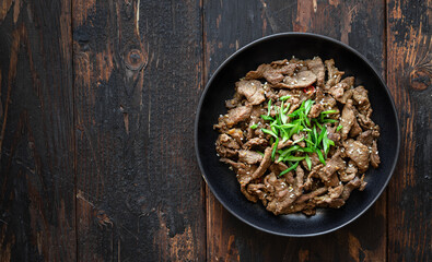 bulgogi with rice on old wooden background, traditional korean beef dish, asian food, top view, copy space