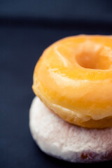 classic glazed donut.Flat lay donut on black plate.sweet doughnut dessert bakery.Unhealthy tasty donut.bakery menu.Bite eat bakery, diet, calories, sugar.