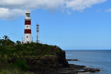 Fototapeta na wymiar Beautiful, old lighthouse overlooking the ocean to preserve the safety of coasts and ships.