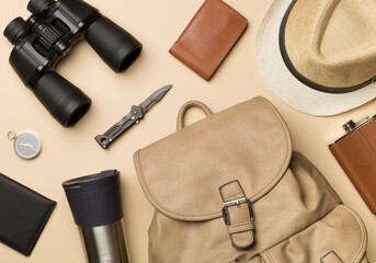 Travel accessories for mountain trip on color background, top view