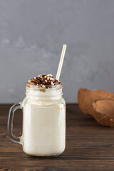 Milkshake with chocolate and nuts on a wooden table. Vegan, sugar and lactose free.