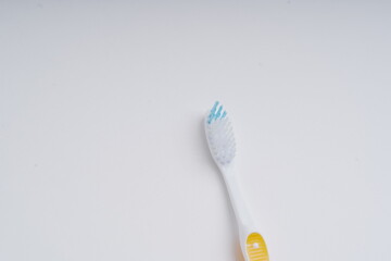 toothbrush and toothpaste on white background