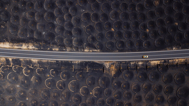 Spain, Lanzarote, Aerial view of highway cutting through Bodega La Geria vineyard