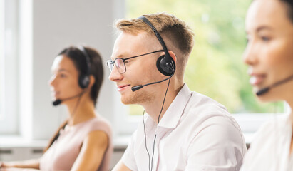 Team of professional support staff working in the office. Colleagues in the workplace solve customer problems. Call center and customer support concept.