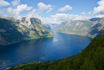 View  from Stegastein view point over Aurlandsfjorden with mountains and blue sky with clouds in...