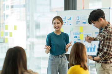 Obraz premium Group of young Asian business people meeting working with new startup project idea presentation analyze plan marketing and investment.