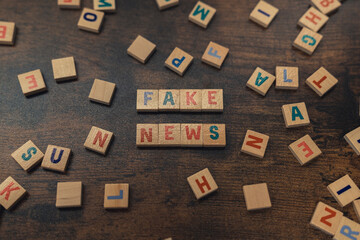 Fototapeta na wymiar FAKE NEWS - a phrase made of wooden blocks with letters social media concept. High quality photo