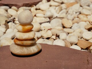 Fototapeta na wymiar The Balance Stones are stacked as pyramids in a soft natural bokeh background, representing the calm philosophical concept of Jainism's wellness.