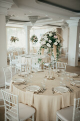 Decoration with fresh flowers, candles, light bulbs, garlands. Vintage style. Table setting for an event party or wedding reception. Event decorations.