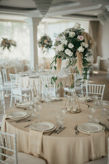 Decoration with fresh flowers, candles, light bulbs, garlands. Vintage style. Table setting for an event party or wedding reception. Event decorations.