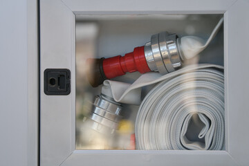 Close up view of a hydrant protected by glass and ready to be used for emergency fires.
