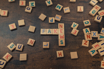 FAKE NEWS - a phrase put together perpendicularly of wooden letters social media concept. High quality photo