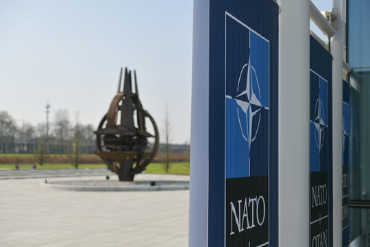 NATO Logo Flags In Front Of The Headquarters Building In Brussels, Belgium, 2022.