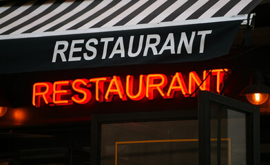 Fototapeta premium Restaurant logo with red light on a terrace. Going out industry.