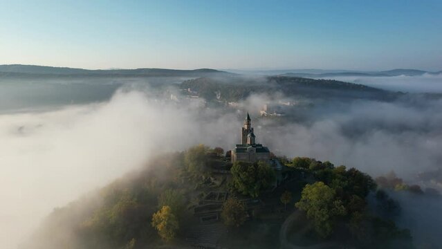 Aerial foggy sunrise view of Tsarevets Fortress in Veliko Tarnovo in a beautiful autumn  day