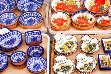 Naklejka na ściany i meble A collection of colorful Portuguese ceramics, local handicrafts from Portugal. Ceramic plates in Portugal. Colorful vintage ceramic plates in Evora, Portugal.