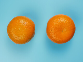 Creative concept made from oranges on blue pastel background. healthy and minimal fruit concept