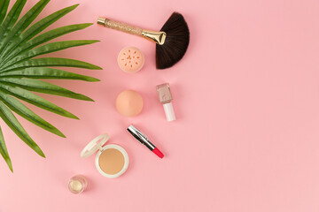 cosmetics and bag on pink background