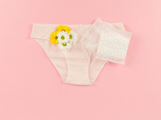 woman pad and flowers on pink background