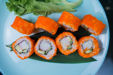 a Japanese roll with tuna and white rice in tobiko caviar