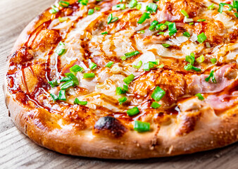 Pizza with chicken and barbeque sauce. Italian pizza on wooden table background
