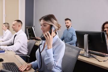 Fototapeta na wymiar Call center operators working in modern office