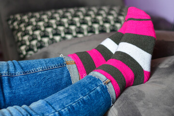 Close-up of woman wearing Magenta   socks while   resting for workout on a sofa at home. 