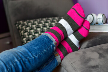 Close-up of woman wearing Magenta   socks while   resting for workout on a sofa at home. 