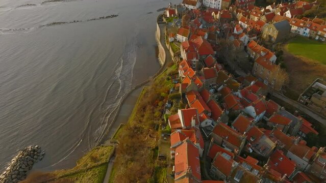 North York Moors Heritage Coast, Robin Hoods Bay, Aerial drone flight over RHB village early morning pull back from slipway then pan up reveal DJI Mavic 3 Cine Prores 422 March 2022 Clip 2