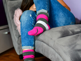 Close-up of woman wearing Magenta   socks while   resting for workout on a sofa at home. 