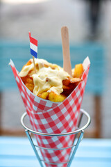 Dutch War Fries  with the Canals of Amsterdam on the background. Typical Dutch street food...