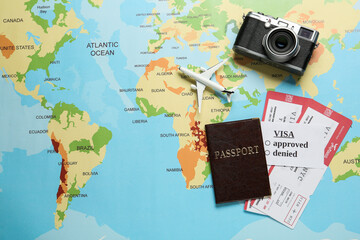 Fototapeta na wymiar Flat lay composition with passport and tickets on world map. Space for text