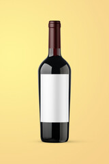 A red wine bottle isolated on a yellow background for mockup presentation projects.