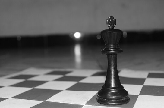 chess king standing alone on chess board
