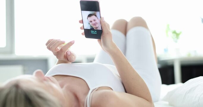 Young woman chooses man on dating site