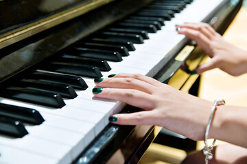 Woman hands on the piano keys