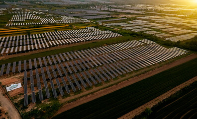 Aerial shot of sunrise sunlight shining on solar photovoltaic panels