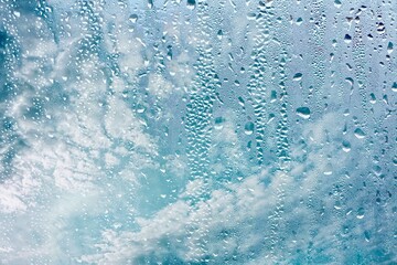 raindrops on the window and blue sky background