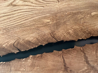 Crack in a wooden plank filled with epoxy. Close-up. Texture, pattern, background, soft focus....