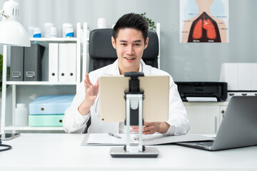 Asian male medical doctor talking virtual online with patient at home. 