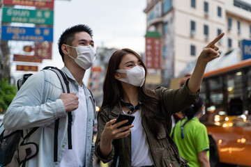Fototapeta premium Asian attractive romantic couple travel in the city for honeymoon trip