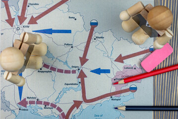 Map of the offensive Ukraine and the figure of a military man in a suit. Concept: The war in...